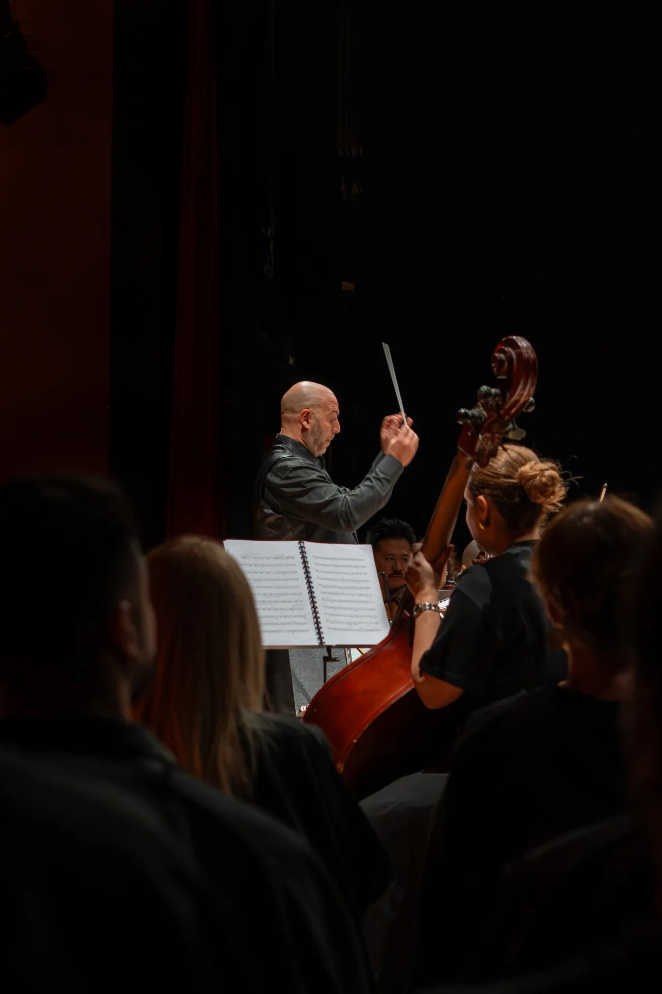 Conductor directing a live orchestral performance